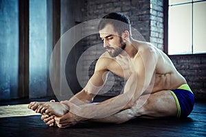 Man at the gym doing stretching