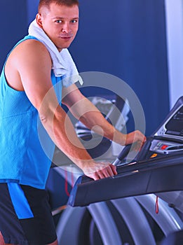 Man at the gym exercising on cross trainers