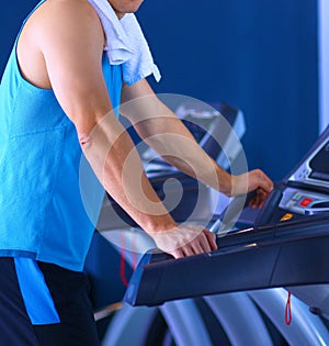 Man at the gym exercising on cross trainers