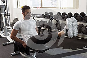 Man in gym, leg raise, abdominal muscles