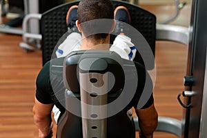 Man in gym on machine exercising