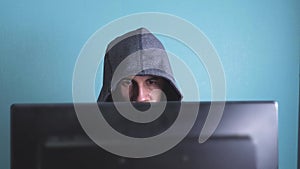 Man hacker in the hood hacking lifestyle network concept. unknown hacker criminal breaks into computer protection on the