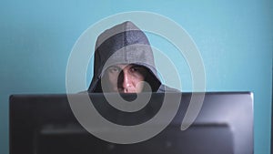 Man hacker in the hood hacking network concept lifestyle . unknown hacker criminal breaks into computer protection on