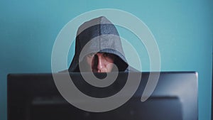 Man hacker in the hood hacking network concept. Unknown hacker criminal breaks into computer lifestyle protection on the