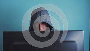 Man hacker in the hood hacking network concept. unknown hacker criminal breaks into computer protection on lifestyle the