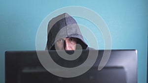 Man hacker in the hood hacking network concept. unknown hacker criminal breaks into lifestyle computer protection on the