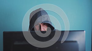 Man hacker in the hood hacking network concept. unknown hacker criminal breaks lifestyle into computer protection on the