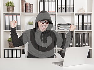 Man hacker using laptop and breaking open password in office