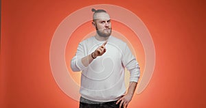 Man with hair in tail disapproving with no finger sign make negation gesture.