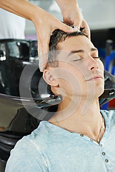 Man hair washing in hairdressing salon