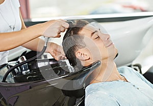 Man hair washing in hairdressing salon