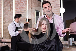 Man hairdresser discussing hairstyling with female client