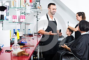 man hairdresser talking to woman