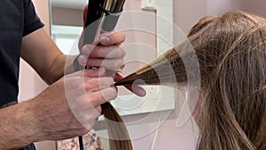 A man hairdresser washes woman's hair after dyeing her hair. Close-up