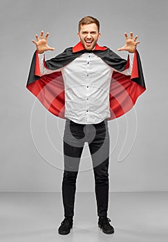 Man in halloween costume of vampire scaring