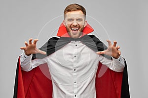 Man in halloween costume of vampire scaring