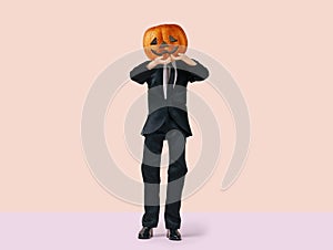 Man with Halloween pumpkin in black costume, minimal holiday concept on pastel background