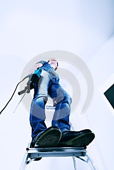 Man with hammer drill in hands.