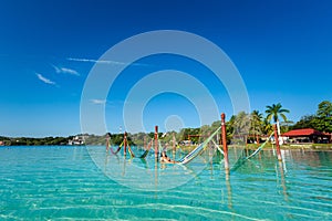 Man on hammock in Bacalar lagoon Mexico