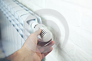 Man Hand Adjusting The Temperature By Thermostat