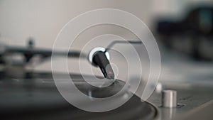 Man hand adjusts the head old record player and vinyl discs at home.