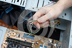 Man hand assembles computer cable