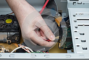 Man hand assembles computer cable