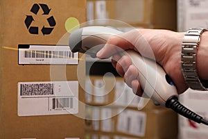 Man hand with barcode scanner in operation.