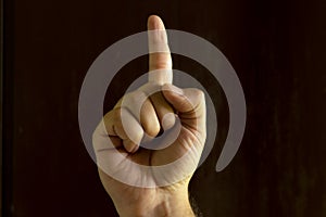 Man hand on black background. Gesture language with the hands. Non-verbal communication concept photo