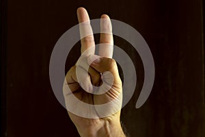Man hand on black background. Gesture language with the hands. Non-verbal communication concept photo
