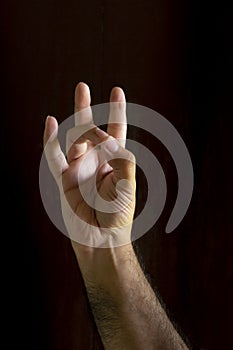Man hand on black background. Gesture language with the hands. Non-verbal communication concept photo