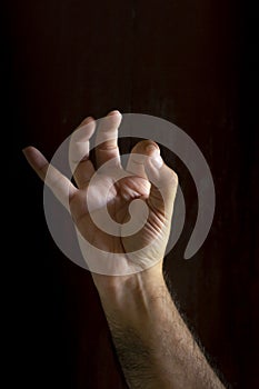 Man hand on black background. Gesture language with the hands. Non-verbal communication concept photo