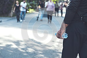 Man hand bottle on water