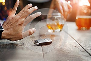 Man hand with car key on table rejecting drinking alcohol