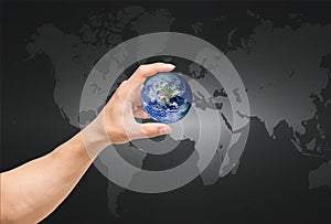 Man hand catching the earth on world map,Elements of this image