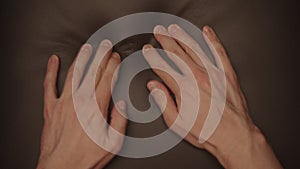 Man hand checking dark brown leather cushion closeup