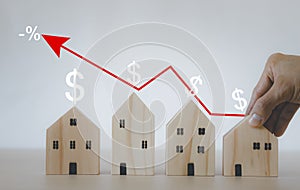 Man hand choosing mini wood house model from model on wood table, Planning buy Real Estate, Planning to buy property, Planning to