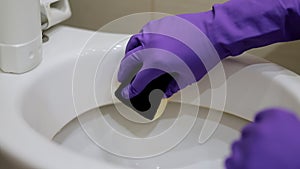 Man hand cleaning toilet with brush