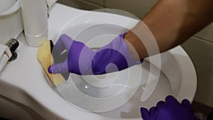 Man hand cleaning toilet with brush