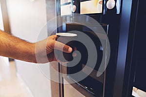 Man hand with coffee, vending coffee machine photo