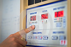 Man hand the controls of a modern machine