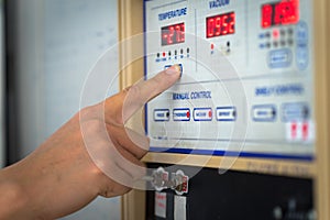 Man hand the controls of a modern machine