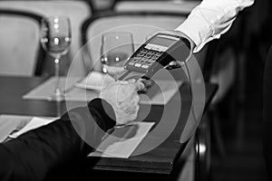 Man hand with credit card swipe through terminal for sale