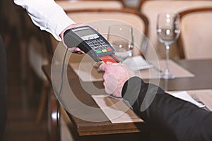 Man hand with credit card swipe through terminal for sale