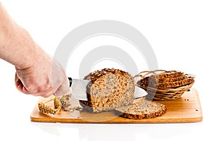 Man hand cutting bread isolated on white background