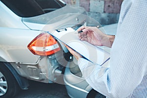 Man hand documant and car crash accident. photo