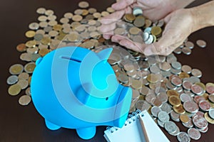 Man hand earn money from saving in piggy bank