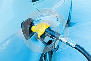 Man hand fill up fuel at gas station