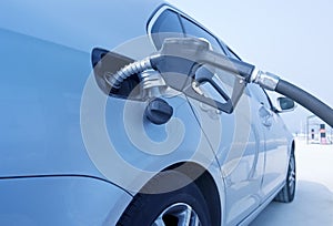 Man hand fill up fuel at gas station