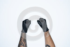 A man hand and gestures in Black rubber glove shows fist scat sign isolated on white background